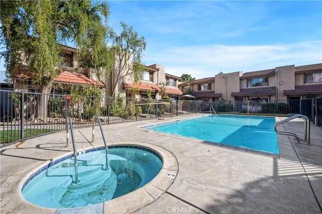 view of swimming pool featuring a community hot tub