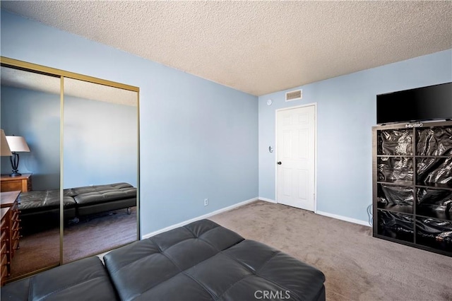 interior space featuring carpet flooring and a textured ceiling