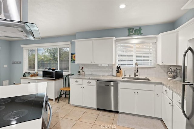 kitchen with extractor fan, sink, white cabinets, light tile patterned floors, and stainless steel appliances