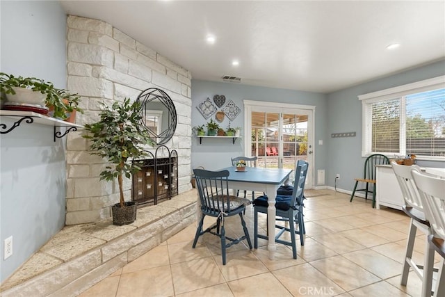 dining room with light tile patterned flooring and a wealth of natural light