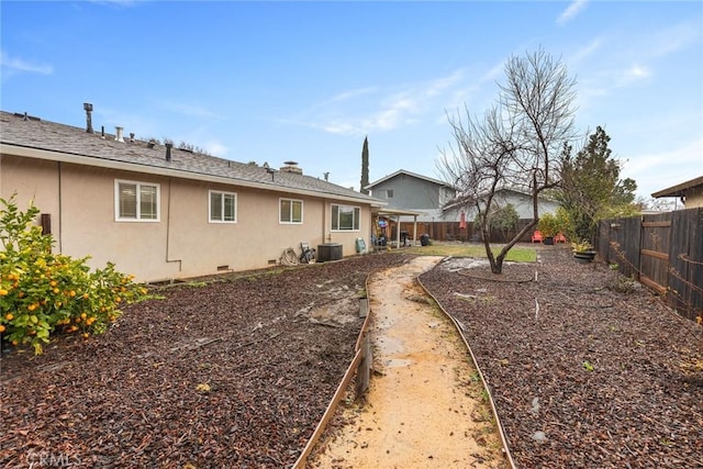 rear view of property with central AC