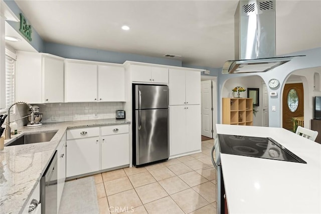 kitchen with white cabinets, appliances with stainless steel finishes, sink, and island range hood