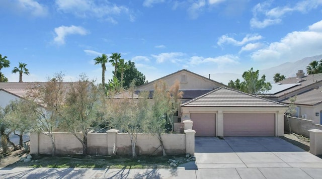 view of front of property with a garage and a mountain view