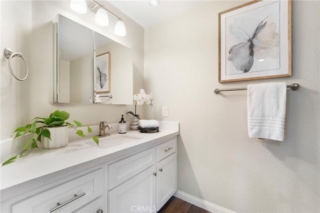 bathroom with vanity and hardwood / wood-style floors