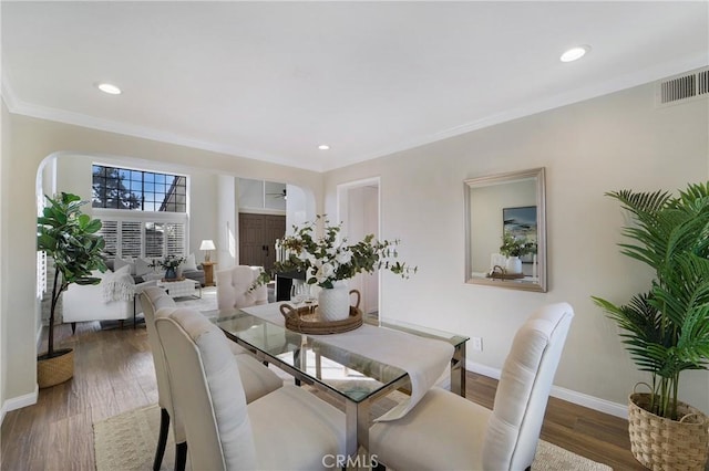 dining space featuring dark hardwood / wood-style flooring and crown molding