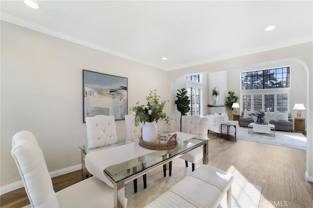 dining area featuring crown molding and light hardwood / wood-style floors