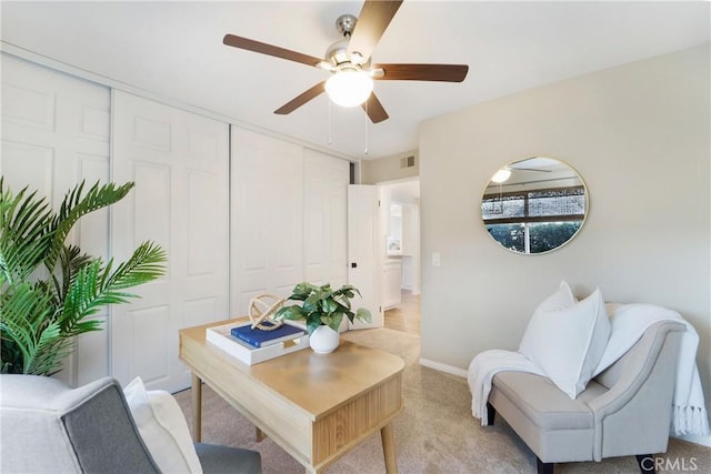 office area with light colored carpet and ceiling fan