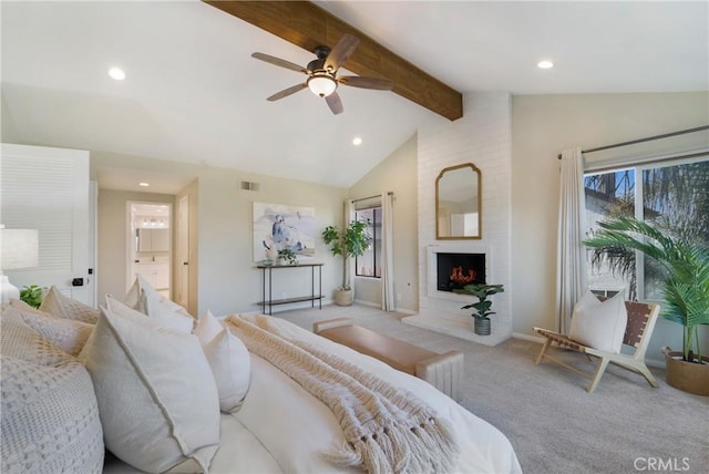 bedroom featuring ceiling fan, a fireplace, light carpet, and vaulted ceiling with beams