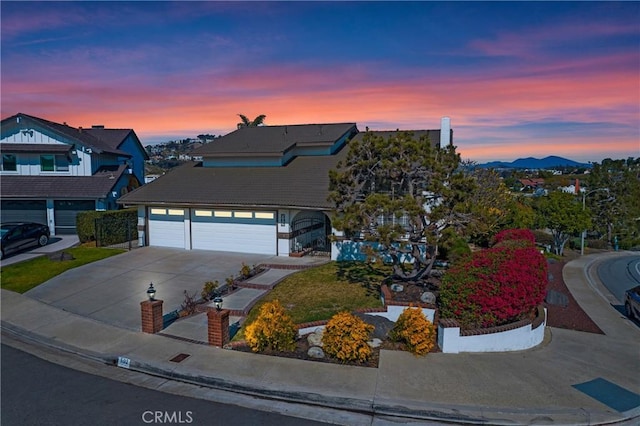 view of front facade featuring a garage and a mountain view