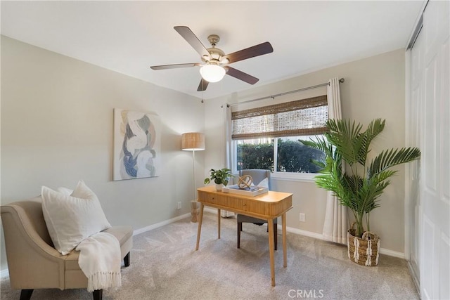 home office with light carpet and ceiling fan