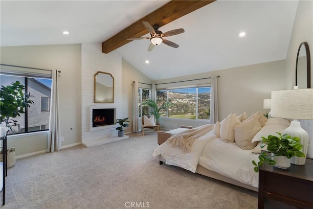 carpeted bedroom with a brick fireplace, lofted ceiling with beams, and ceiling fan