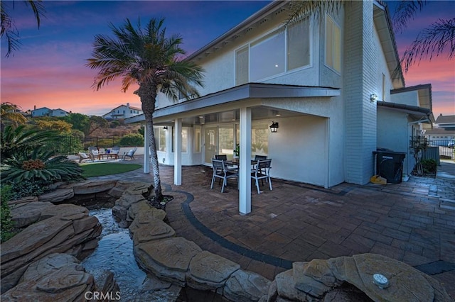 view of patio terrace at dusk