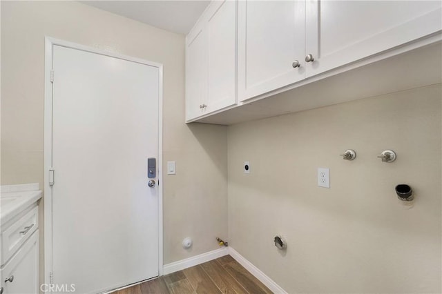 washroom with dark hardwood / wood-style flooring, hookup for a gas dryer, cabinets, and hookup for an electric dryer