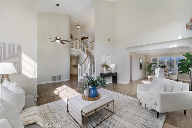 living room featuring hardwood / wood-style flooring and ceiling fan