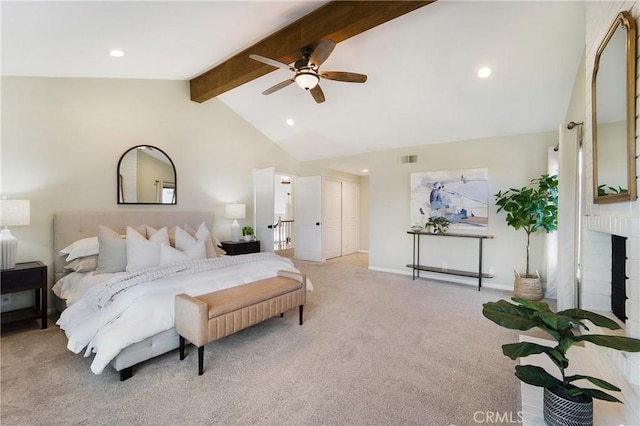 carpeted bedroom featuring ceiling fan, a brick fireplace, and vaulted ceiling with beams