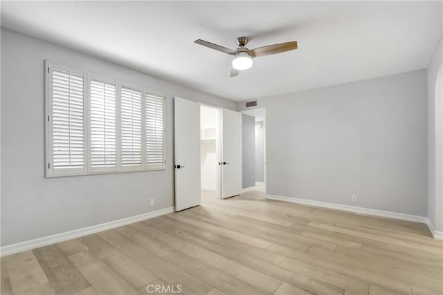 unfurnished bedroom with ceiling fan and light hardwood / wood-style flooring