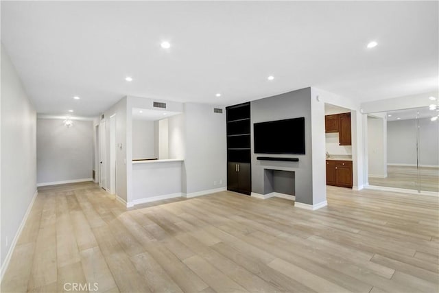 unfurnished living room with light hardwood / wood-style flooring