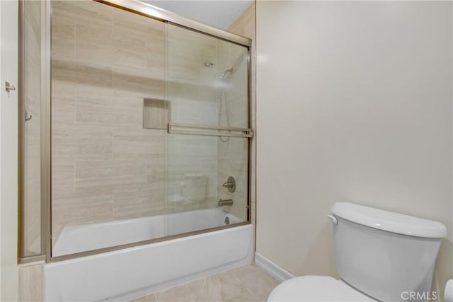 bathroom featuring combined bath / shower with glass door and toilet