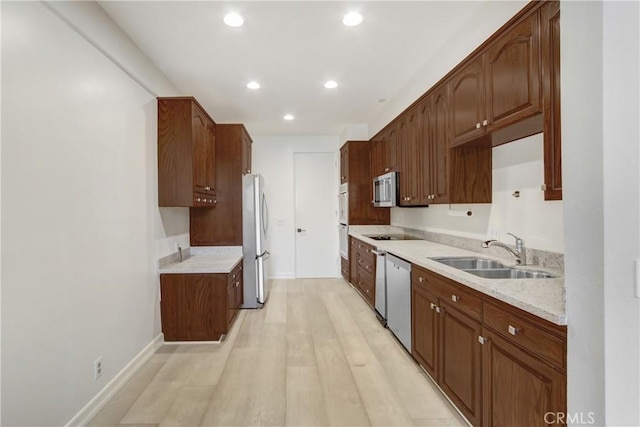 kitchen featuring sink, light hardwood / wood-style floors, and appliances with stainless steel finishes