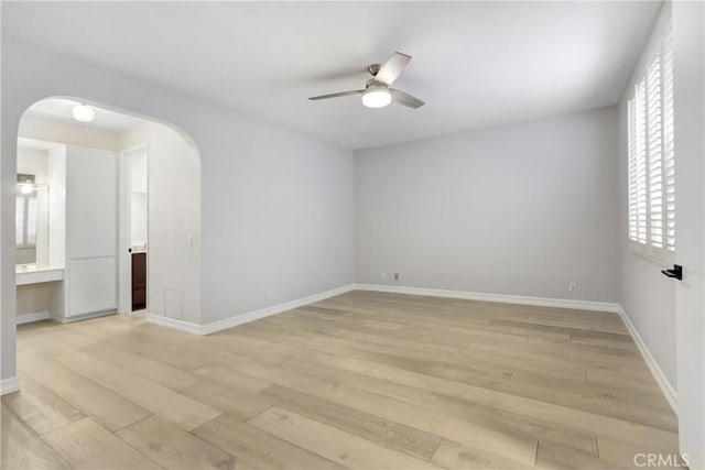 spare room featuring ceiling fan and light hardwood / wood-style flooring