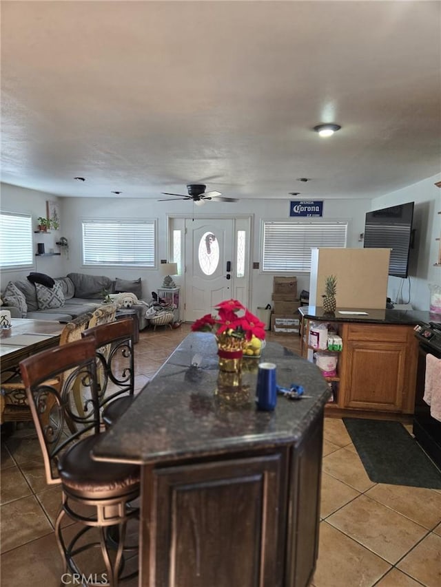 dining room featuring light tile patterned floors and ceiling fan