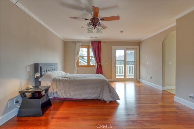 unfurnished bedroom with access to exterior, wood-type flooring, ornamental molding, and ceiling fan