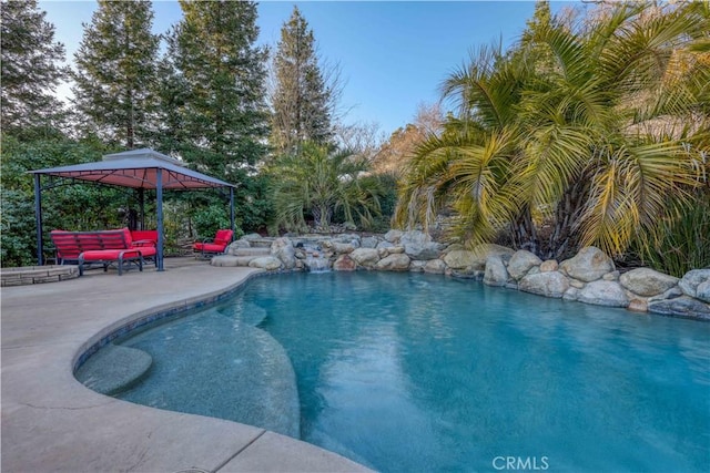 view of pool featuring a gazebo and a patio