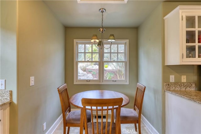 dining space with an inviting chandelier