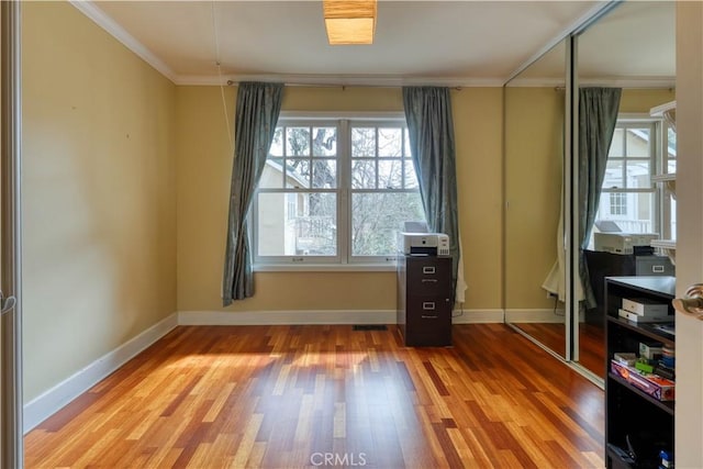 interior space with crown molding and hardwood / wood-style floors