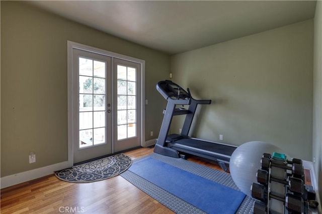 workout area featuring hardwood / wood-style floors and french doors