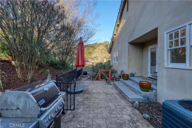 view of patio / terrace with cooling unit and a grill