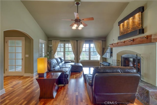 living room featuring hardwood / wood-style flooring, ceiling fan, and lofted ceiling