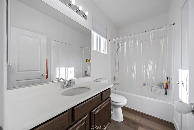 full bathroom with hardwood / wood-style flooring, vanity, toilet, and shower / tub combo