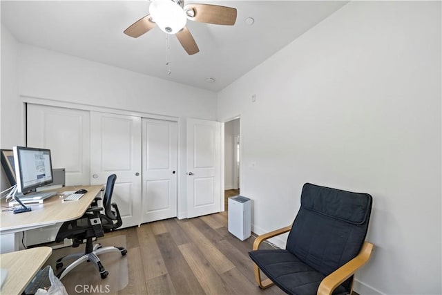 home office with wood-type flooring and ceiling fan