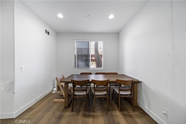 dining space with dark wood-type flooring