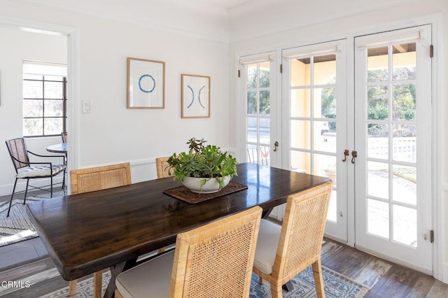 dining area with hardwood / wood-style flooring and french doors