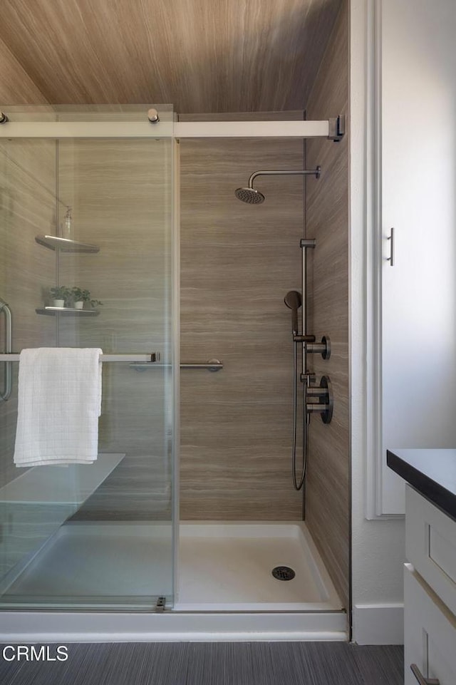 bathroom with walk in shower and vanity