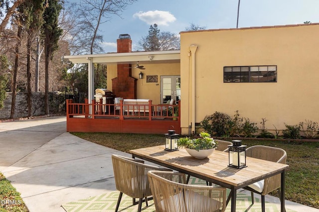 back of property with ceiling fan and a patio area