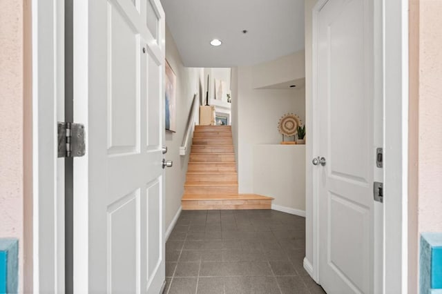 hallway with dark tile patterned flooring