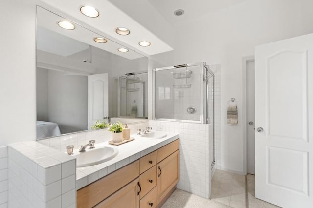 bathroom with an enclosed shower and vanity