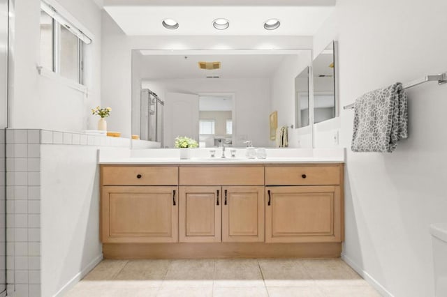 bathroom featuring vanity, tile patterned flooring, and toilet