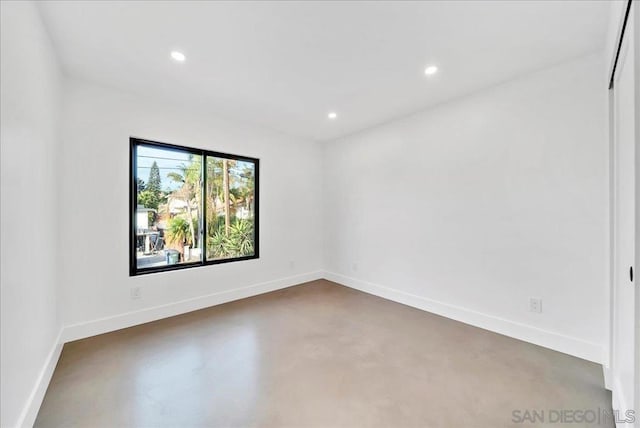 spare room featuring concrete flooring