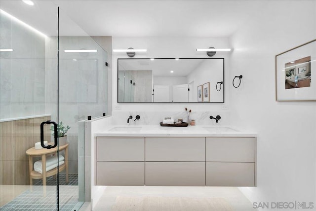 bathroom with vanity and a shower with shower door