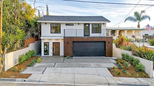 view of front of house featuring a garage and a balcony