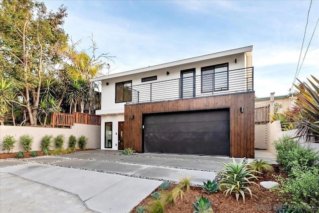 contemporary home with a garage and a balcony