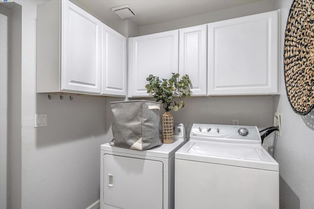 laundry area featuring cabinets and washing machine and clothes dryer