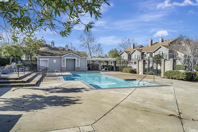 view of swimming pool featuring a patio and a pergola