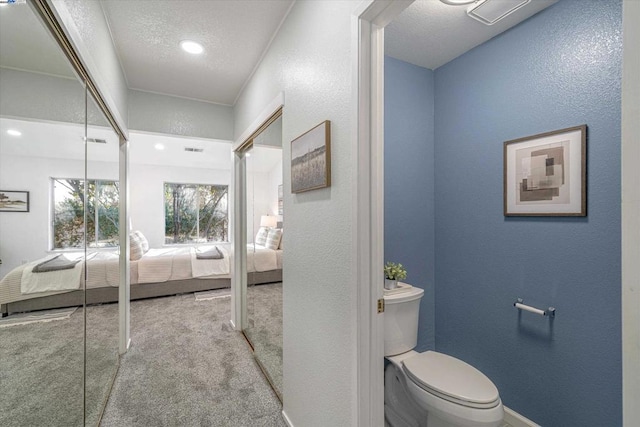 bathroom with a textured ceiling and toilet