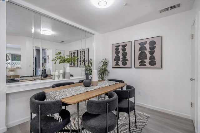 dining space with light hardwood / wood-style flooring