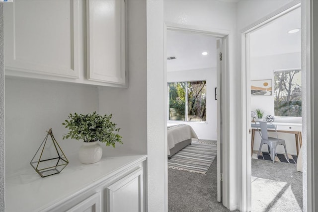 hallway with light colored carpet